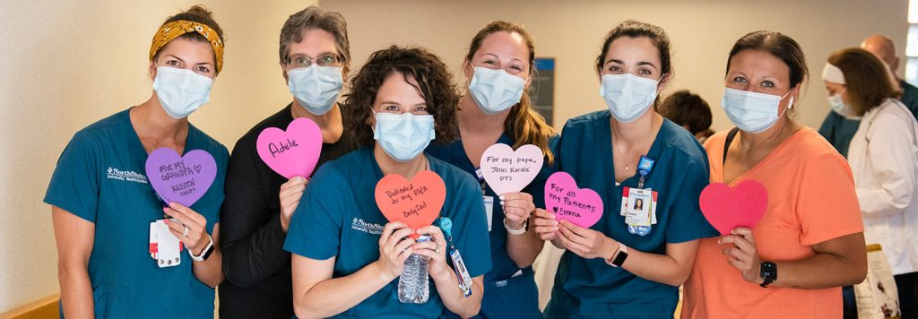 NorthShore nurses holding heart shapes for AHA Heart Walk.